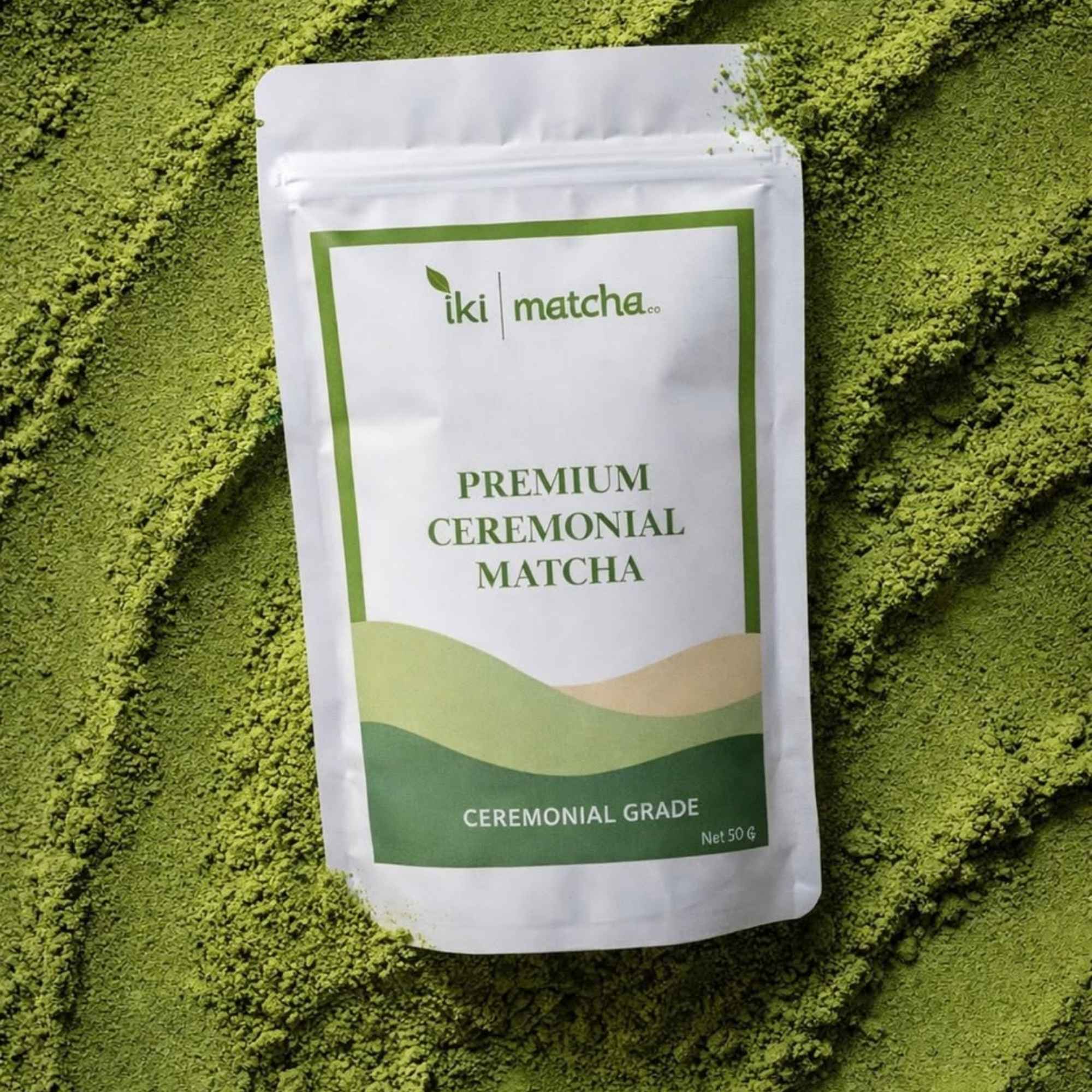 Package of iki matcha premium ceremonial matcha powder on a bed of green matcha powder.