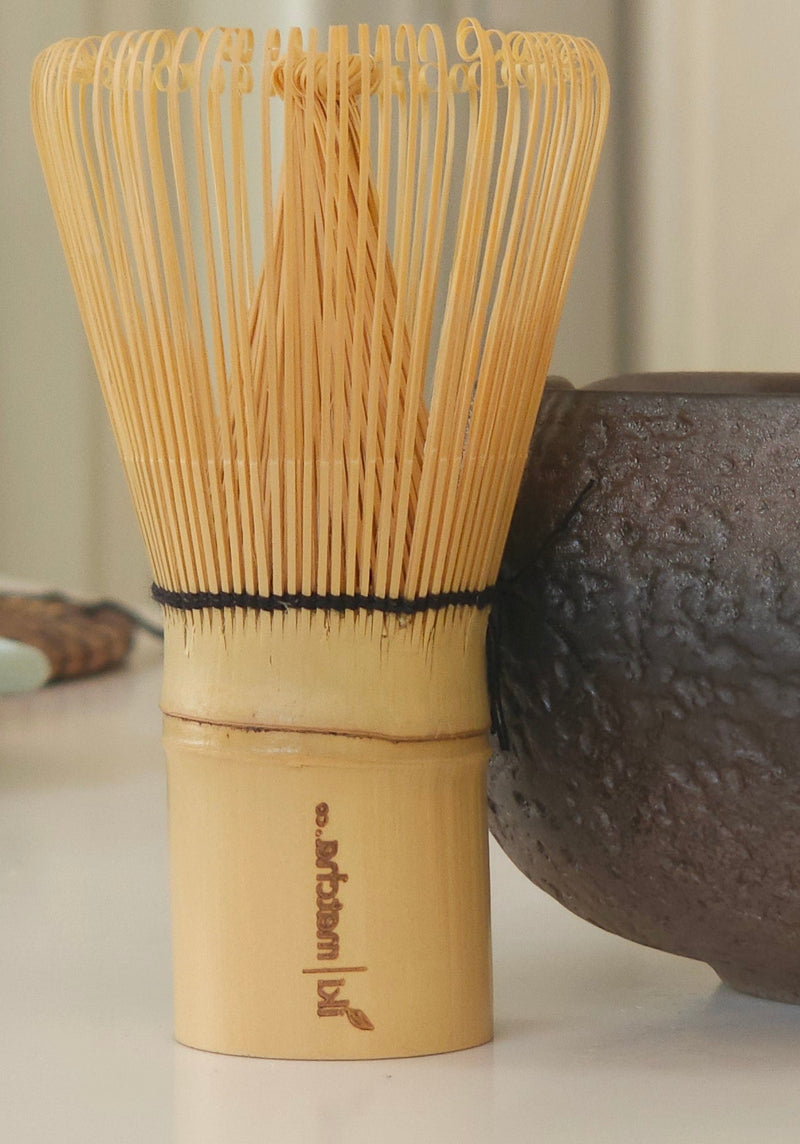 Tea bowl and whisk on a table with a blurred background